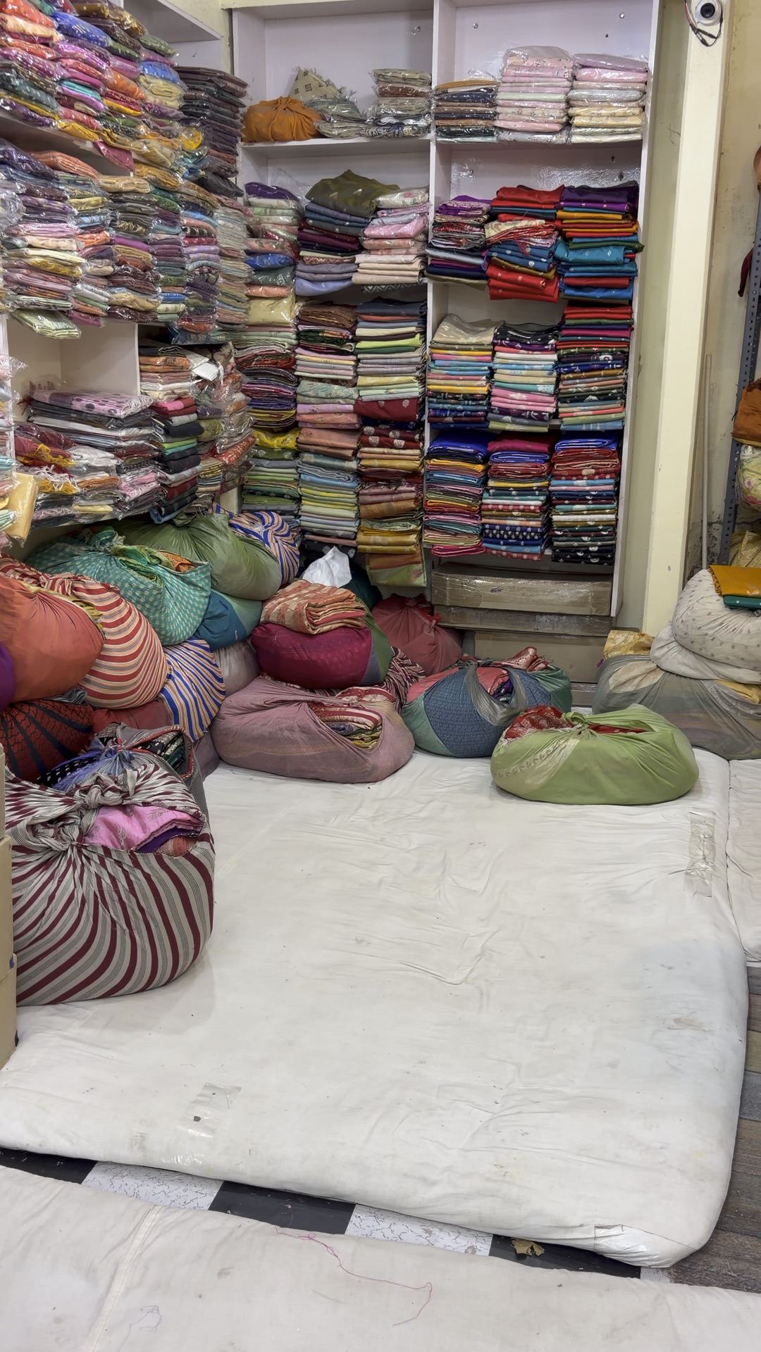 Shelves stacked with sarees inside the Jawahar Sarees gaddi
